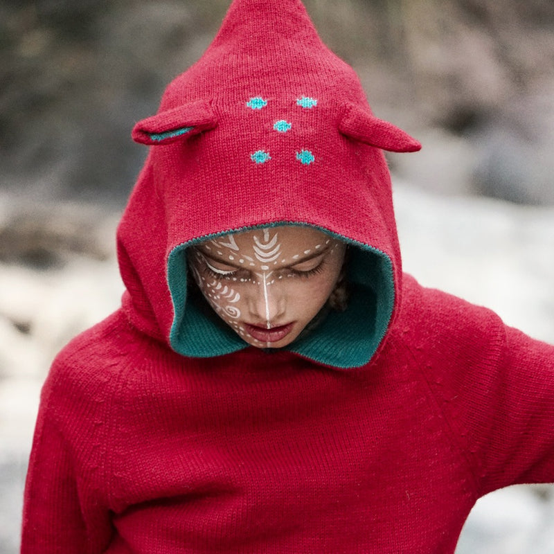 girls wearing a hoody made with baby alpaca wool color red
