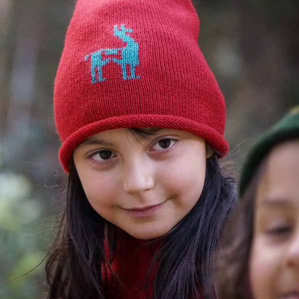 Girl with red colored baby alpaca wool beanie