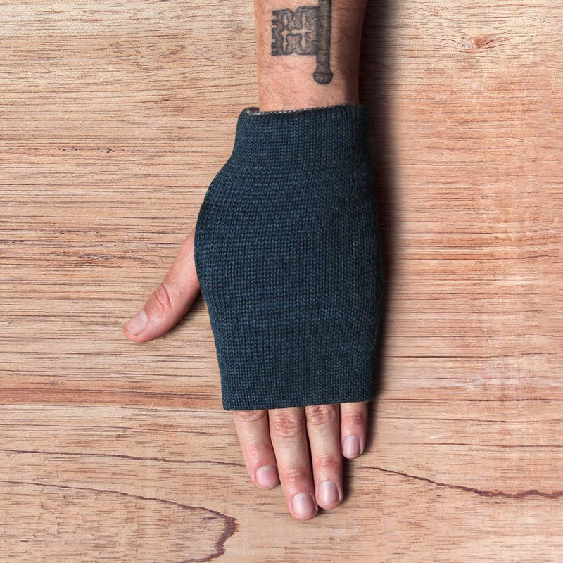 Hand with inside out gloves made of alpaca wool in the color blue