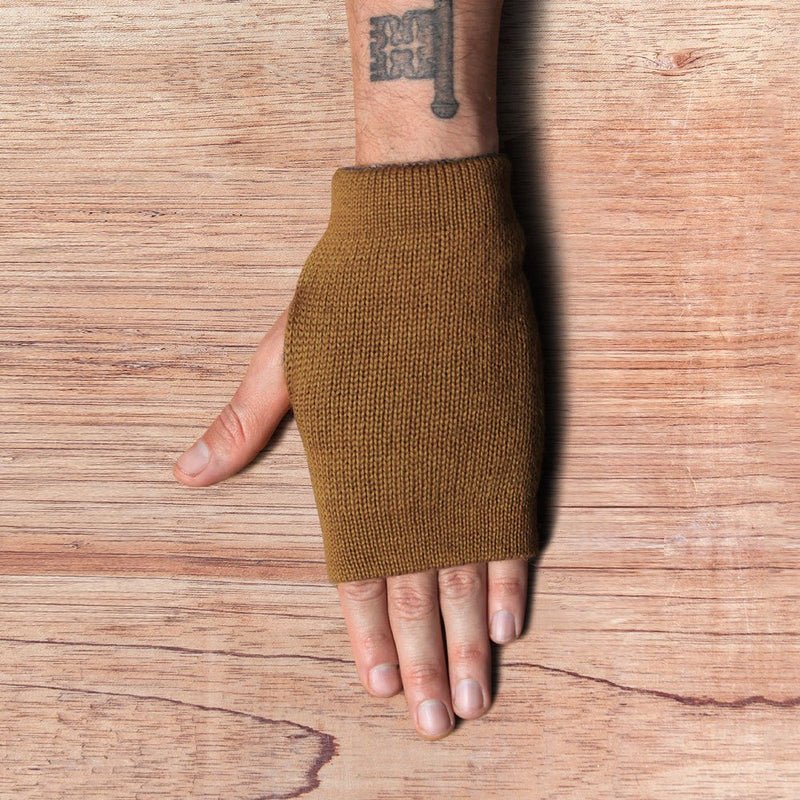 Hand with inside out gloves made of alpaca wool in the color brown