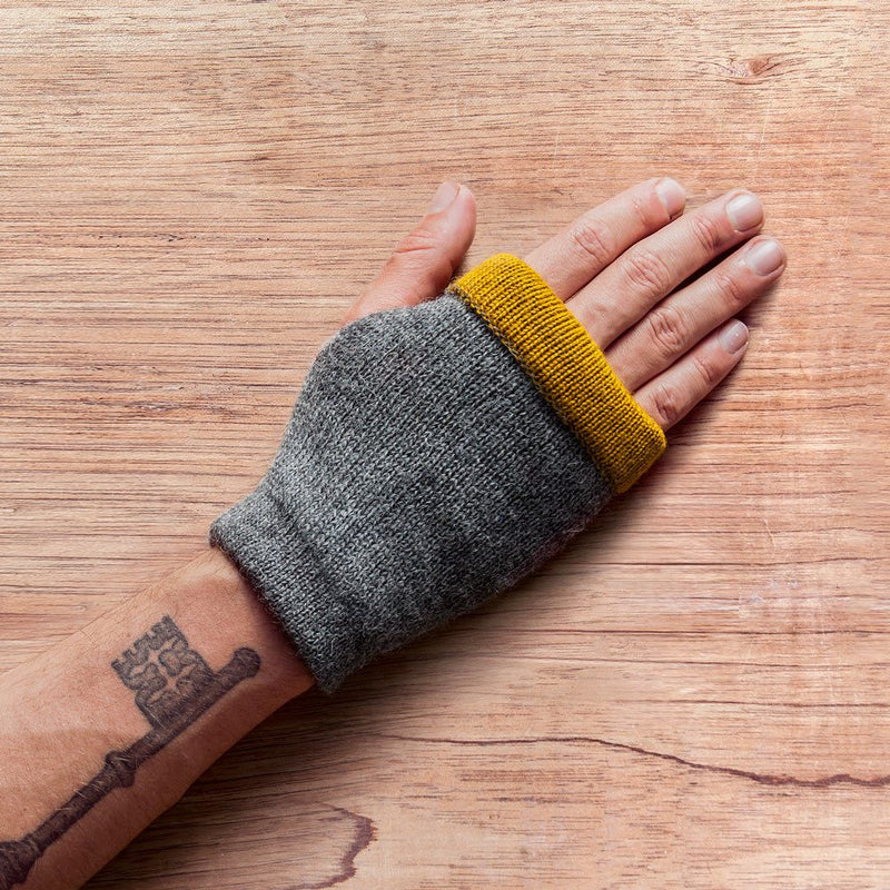 Hand with inside out gloves made of alpaca wool in the color grey