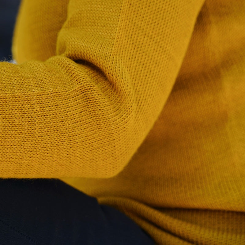 Close up sweater made of baby alpaca wool in the color mustard